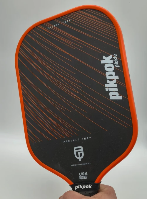 Close-up of the Panther Fury paddle by Pikpok Pickle on a pale background, showcasing surface texture, carbon face, and detailed finish