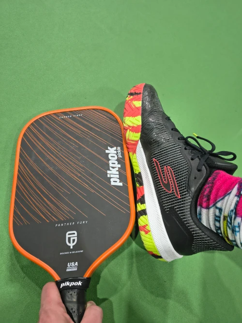 Panther Fury paddle held next to matching Tyson McGuffin Skechers Viper Court 2 shoes, showing colour coordination and pickleball gear style