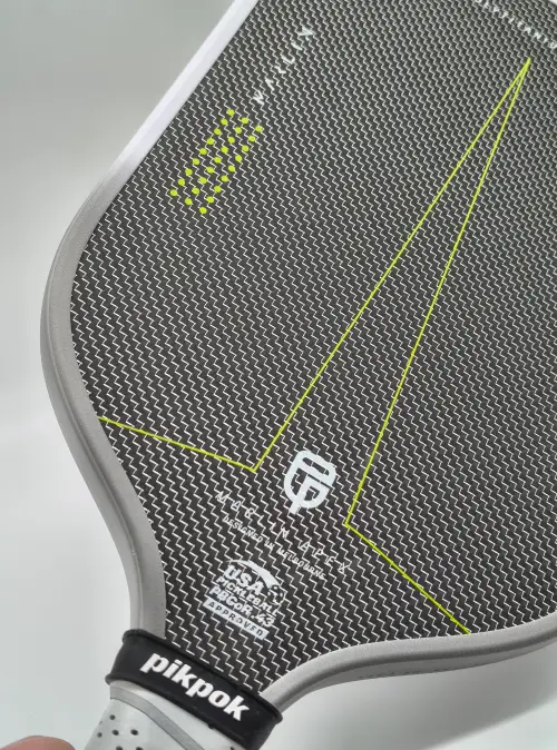 Close-up of PikPok Marlin Apex paddle face showing carbon fibre weave and detailed texture