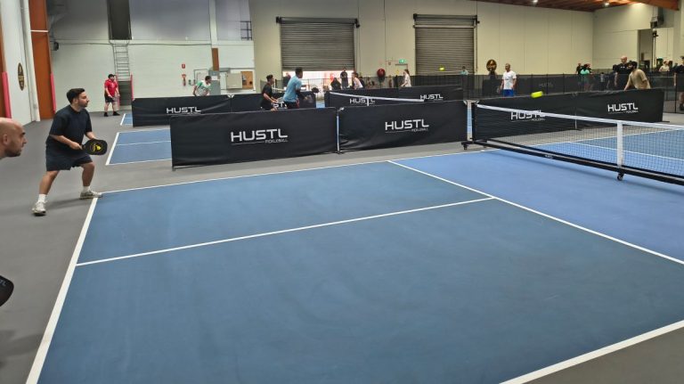 Players competing in an action rally during a local pickleball tournament at Pickleplay Dingley